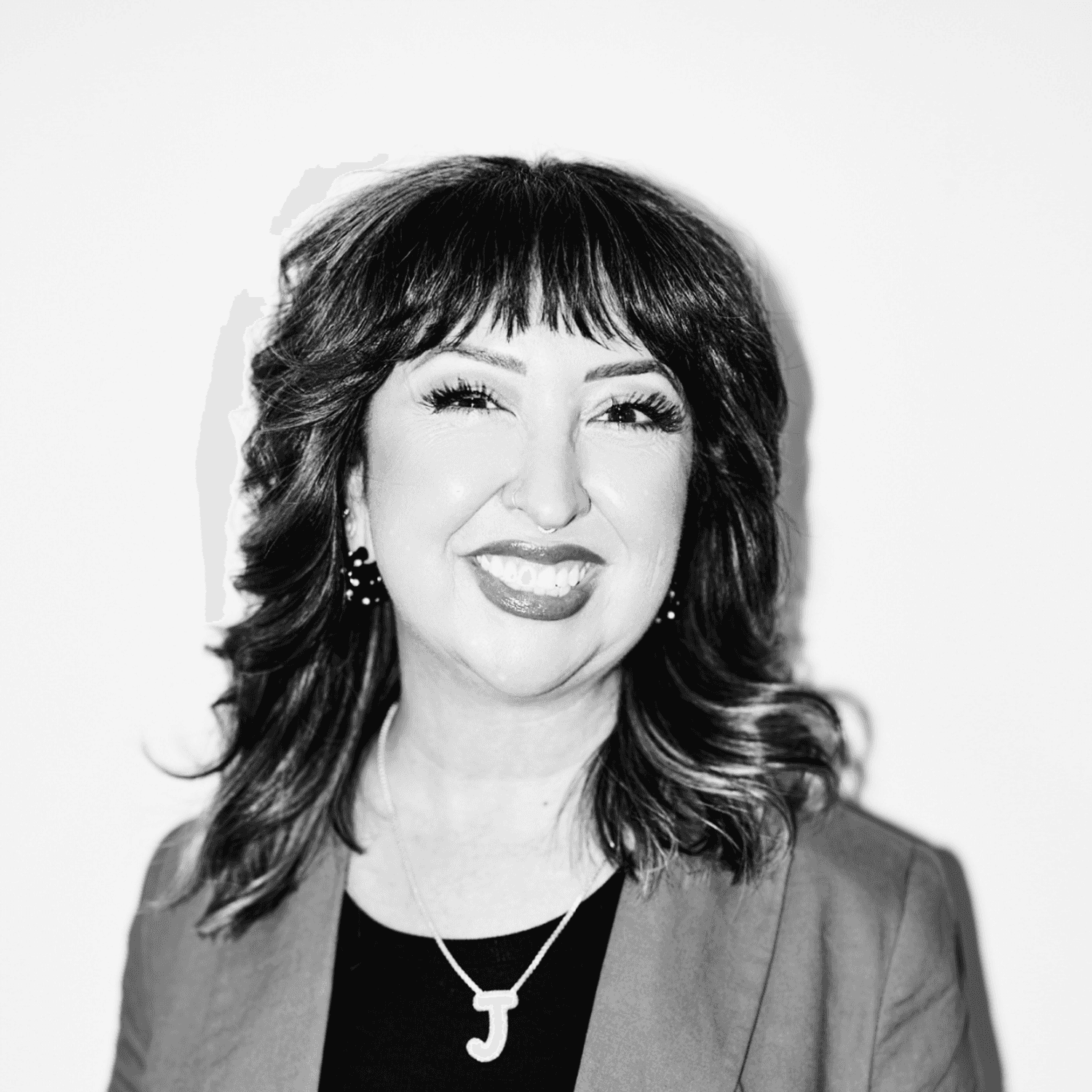 Portrait of Jenn Martínez Foster, a professional stylist at Matthew Morris Salon, showcasing their expertise and style.