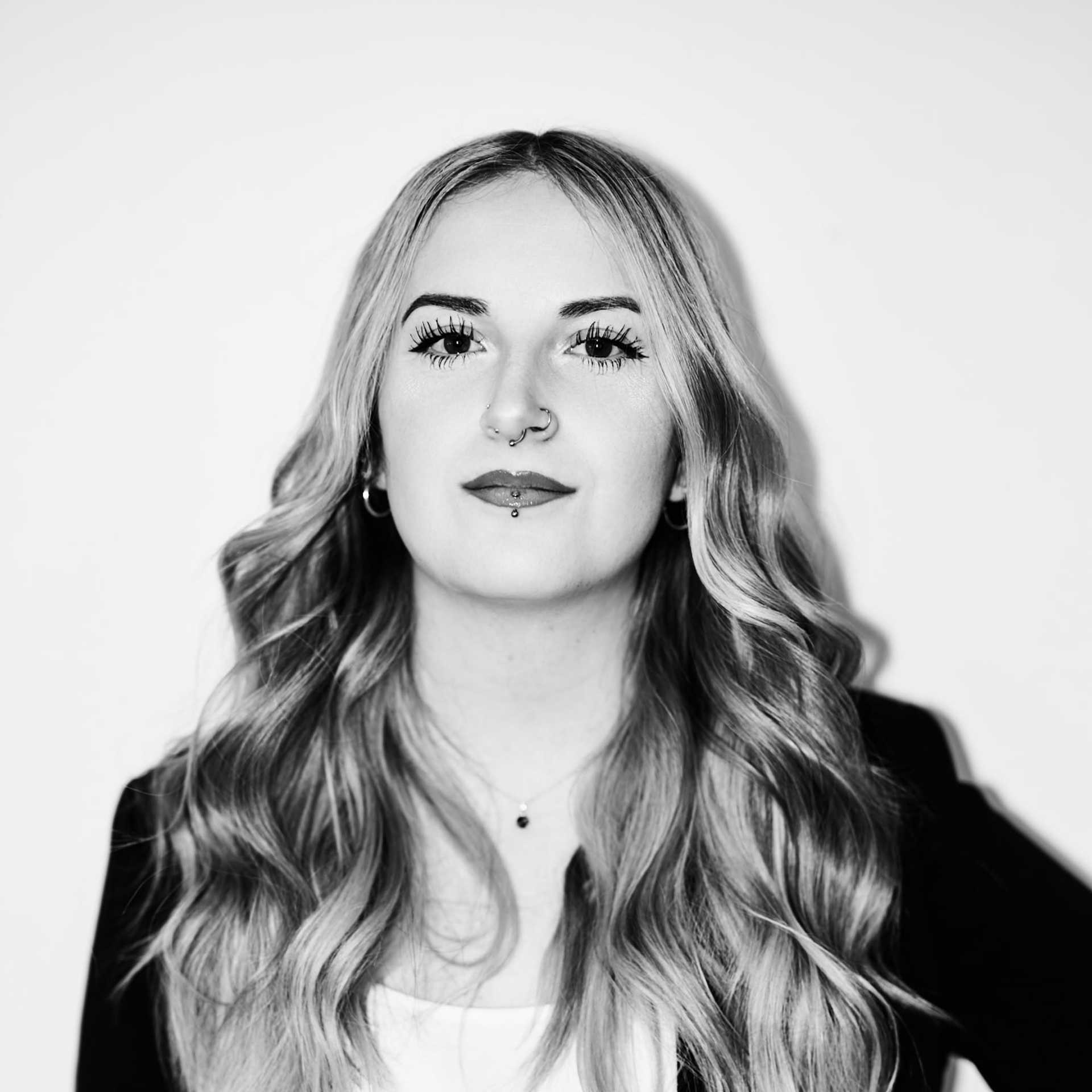 Portrait of Sydney Smith, a professional stylist at Matthew Morris Salon, showcasing their expertise and style.